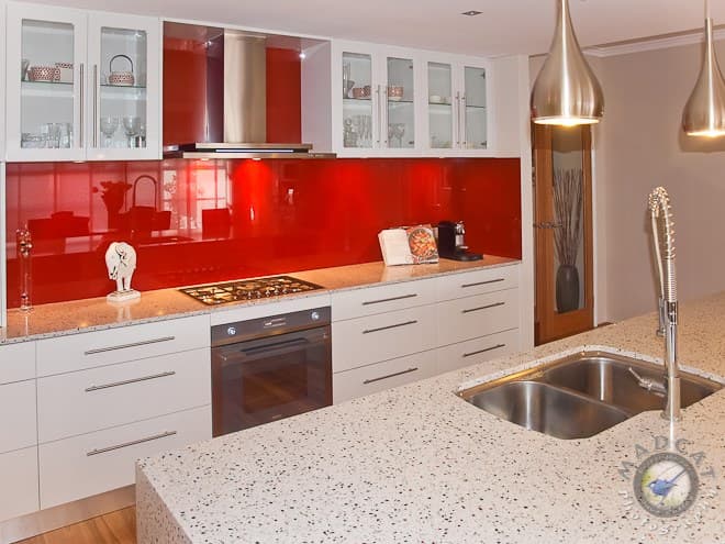 Light-oak and white kitchen cabinetry with a built-in oven and induction cooktop